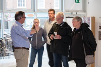 A volunteer greets a group of visitors as they begin their journey round the National Civil War Centre